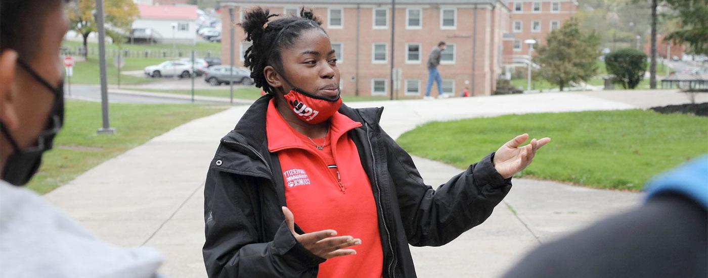 A Bobcat Ambassador gives a tour to prospective students and points out various buildings on campus